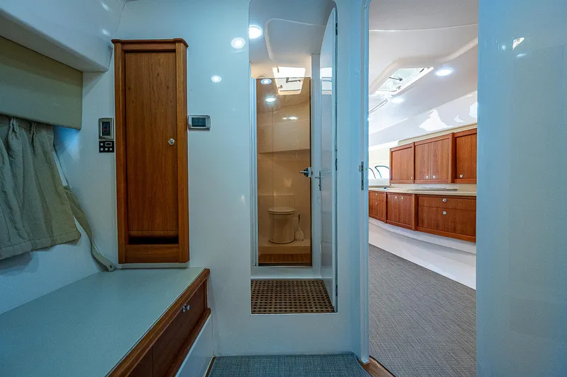 Slide: The Image of Interior of 2014 Intrepid 475 Sport Yacht, featuring wooden cabinetry and modern design. - 37