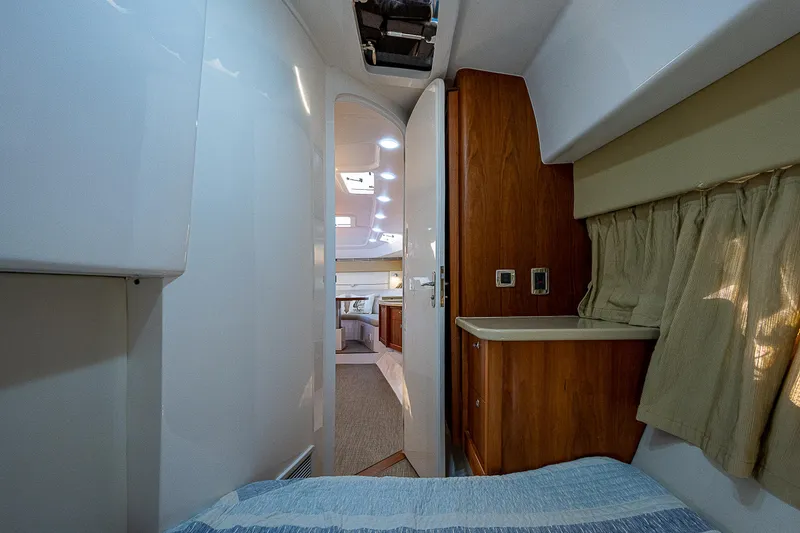 Slide: The Image of Interior cabin of 2014 Intrepid 475 Sport Yacht with wood accents and cozy bedding. - 38