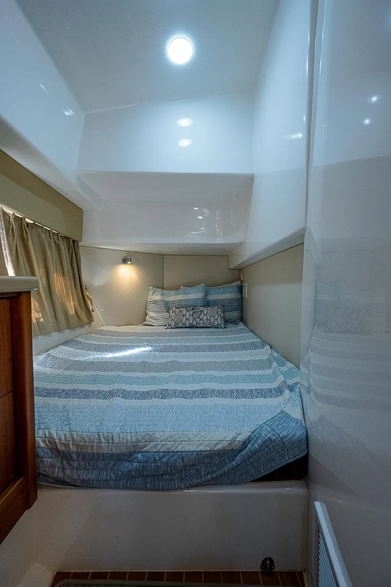 Slide: The Image of Cozy cabin interior of 2014 Intrepid 475 Sport Yacht with bed and ambient lighting. - 39