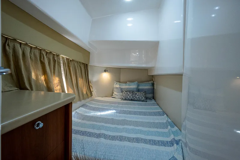 Slide: The Image of Cozy cabin interior of 2014 Intrepid 475 Sport Yacht with bed and curtains. - 41