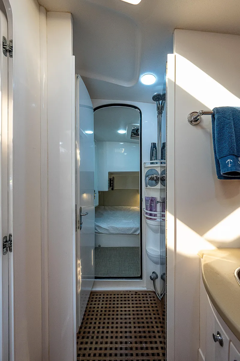 Slide: The Image of Interior of 2014 Intrepid 475 Sport Yacht, featuring a cozy cabin and modern bathroom. - 42