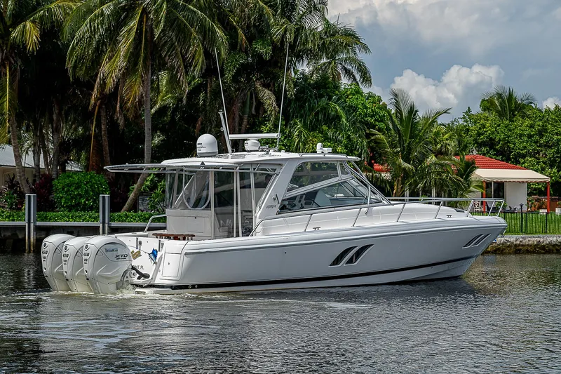 Slide: The Image of 2014 Intrepid 475 Sport Yacht cruising on a tropical waterway. - 48