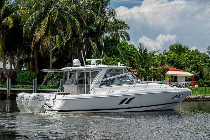 Slide: The Image of 2014 Intrepid 475 Sport Yacht cruising on a tropical waterway. - 49