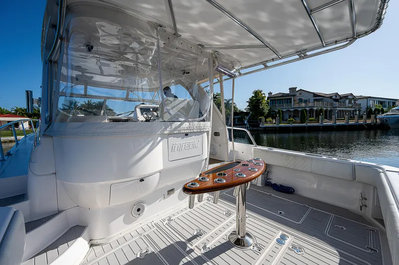 Slide: The Image of 2014 Intrepid 475 Sport Yacht deck with seating and waterfront view. - 8