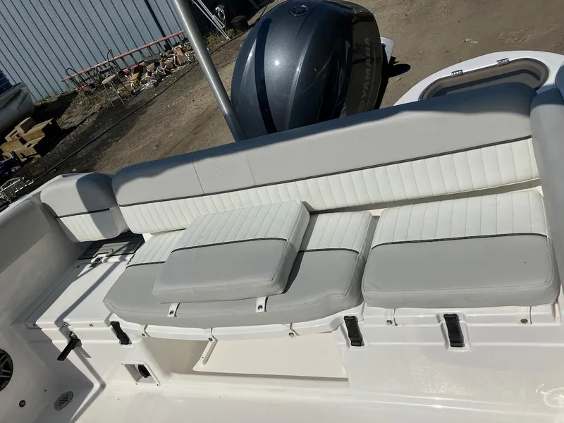 Slide: The Image of 2023 Sea Fox 226 Traveler boat with cushioned seating and outboard motor. - 21