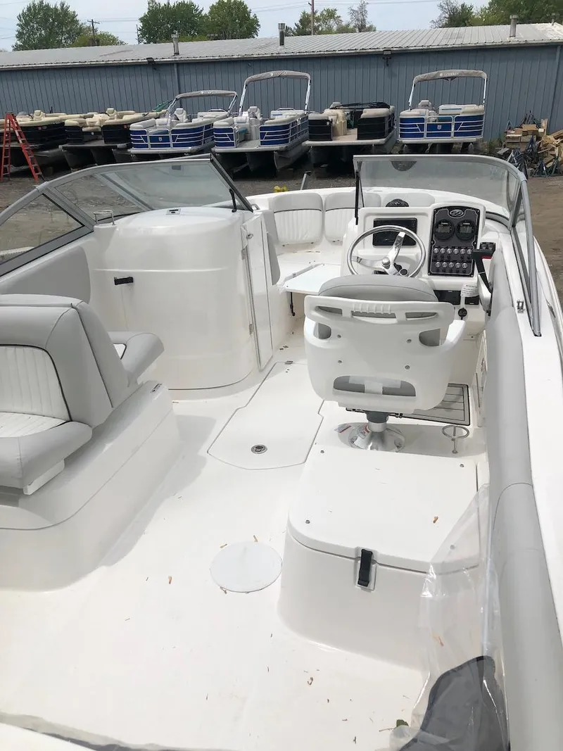 Slide: The Image of 2023 Sea Fox 226 Traveler boat interior with helm, seating, and storage compartments. - 4