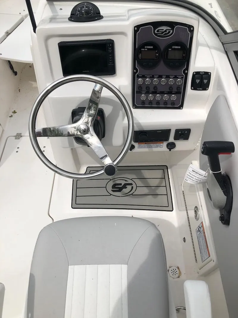 Slide: The Image of 2023 Sea Fox 226 Traveler boat helm with steering wheel and control panel. - 5