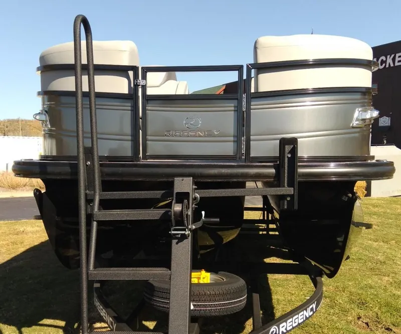 Slide: The Image of 2023 Regency 230 DL3 pontoon boat on a trailer, rear view. - 1
