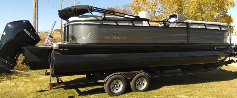 Slide: The Image of 2023 Regency 230 DL3 pontoon boat on a trailer. - 4