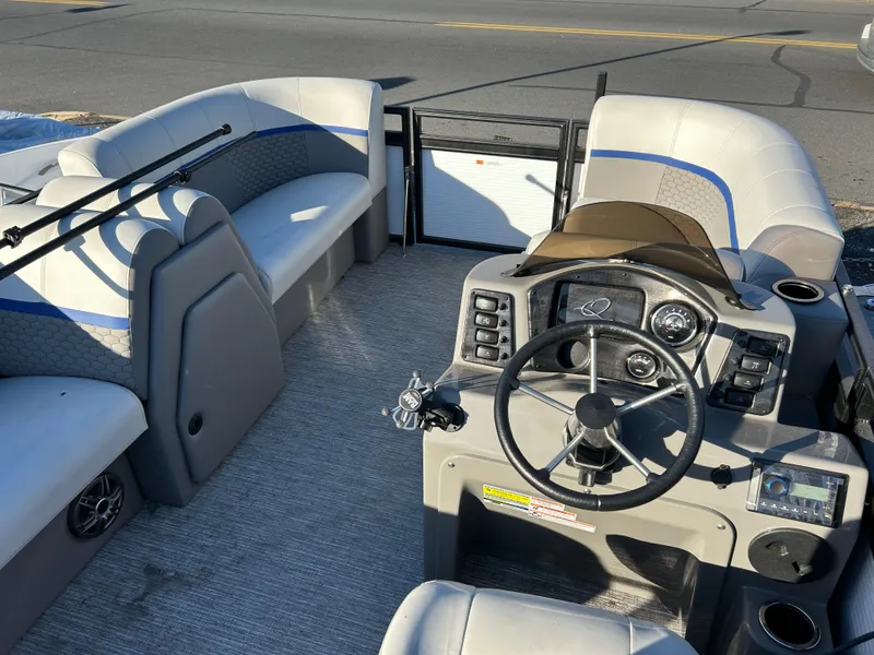 Slide: The Image of 2023 Qwest 814 CTR Cruise boat interior with steering console and seating. - 8