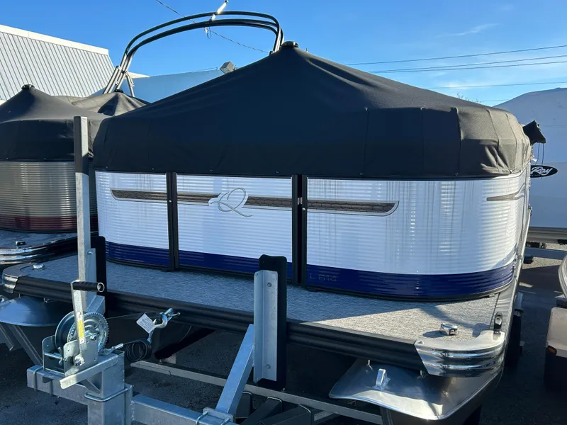 Slide: The Image of 2023 Qwest 814 CTR Cruise boat with cover on trailer, parked outdoors. - 9