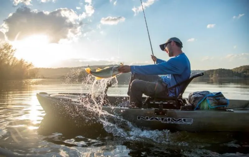 Slide: The Image of Man fishing on a 2023 Native Watercraft Titan Propel 10.5 kayak at sunset. - 5