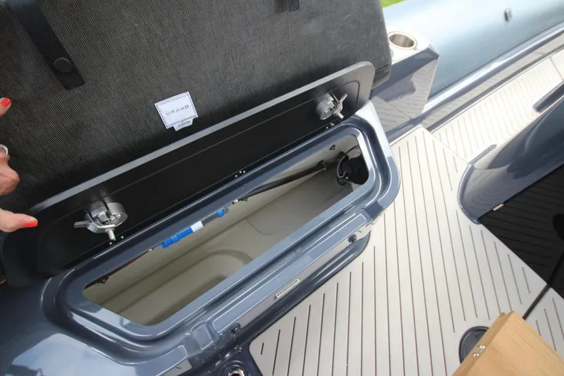 Slide: The Image of 2024 Zodiac MEDLINE 9 NEO Twin 300hp storage compartment open on deck. - 16