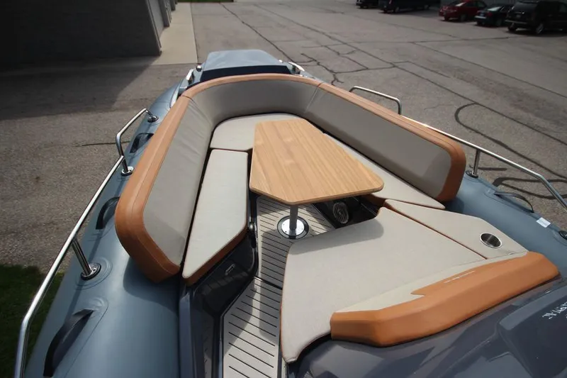 Slide: The Image of 2024 Zodiac MEDLINE 9 NEO Twin 300hp boat with spacious seating and wooden table. - 31