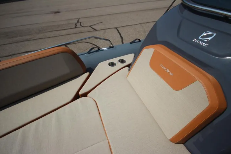 Slide: The Image of 2024 Zodiac MEDLINE 9 NEO Twin 300hp boat seating area with beige and orange upholstery. - 35