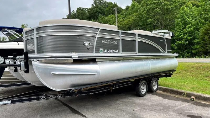 The Image of 2020 Harris FloteBote 210 CX Cruiser pontoon boat on trailer, parked outdoors. - 0