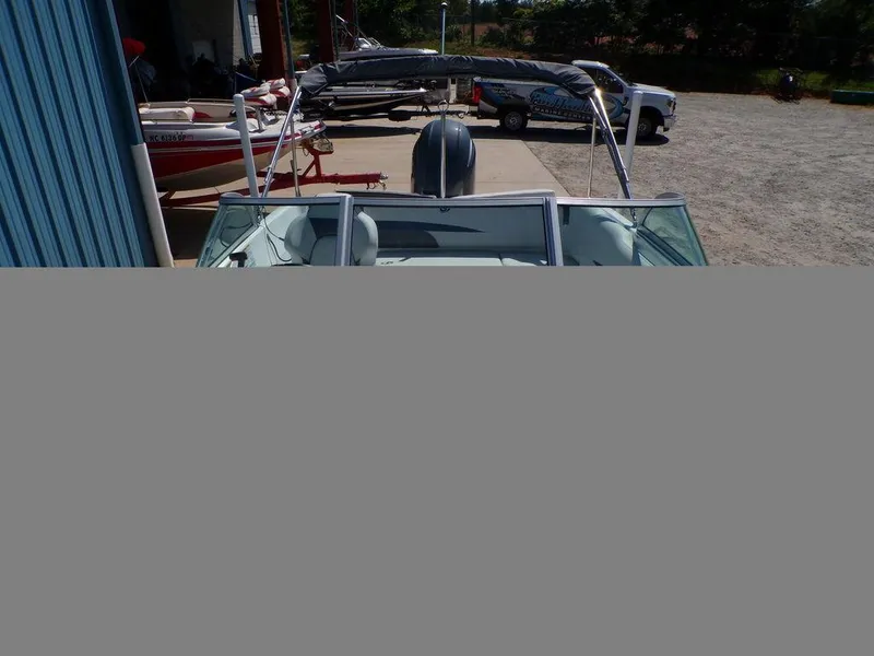 Slide: The Image of 2023 Hurricane SunDeck 187 OB boat with bimini top in a marina. - 11