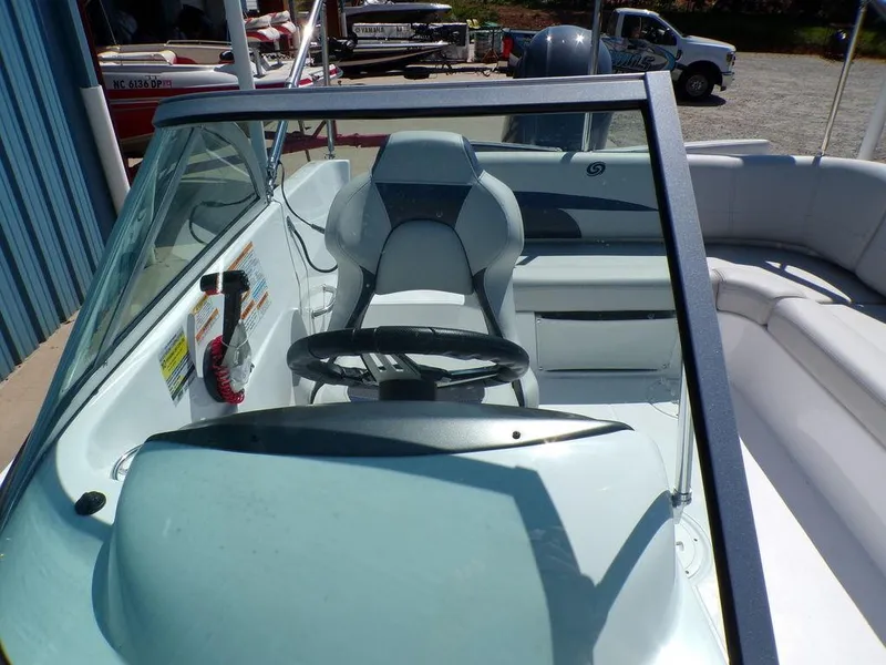 Slide: The Image of 2023 Hurricane SunDeck 187 OB boat interior with steering wheel and seating. - 17