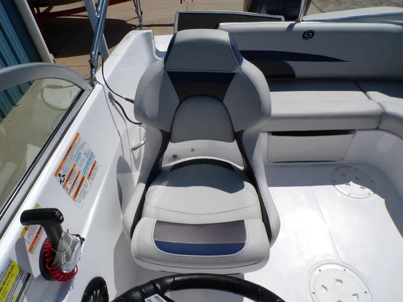 Slide: The Image of Captain's seat of 2023 Hurricane SunDeck 187 OB boat with control panel. - 18