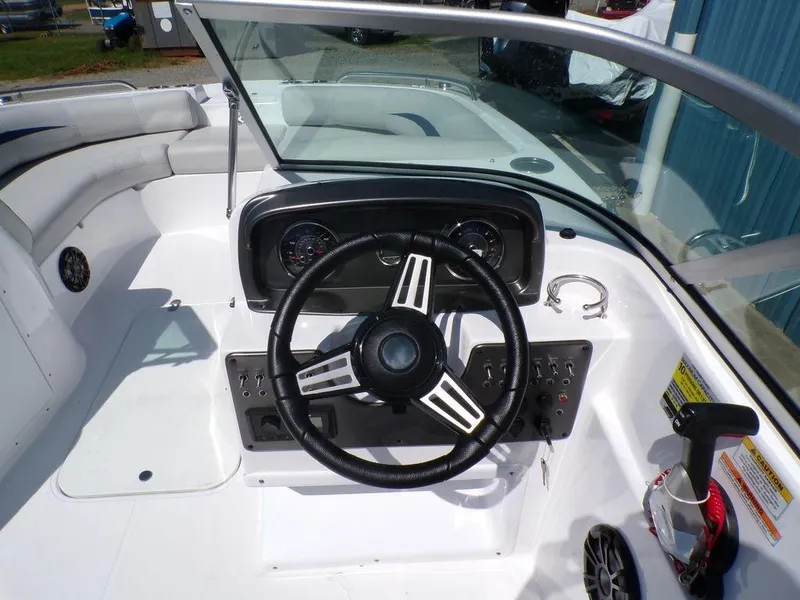 Slide: The Image of 2023 Hurricane SunDeck 187 OB boat cockpit with steering wheel and control panel. - 19