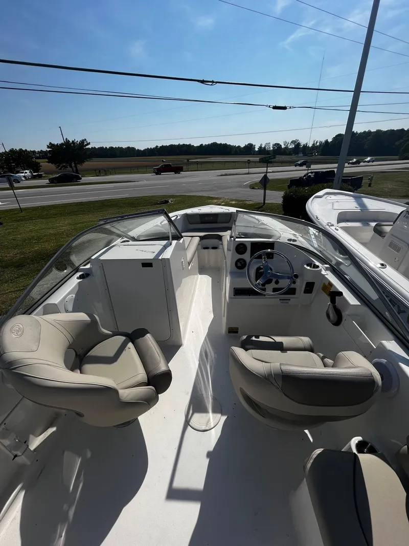 Slide: The Image of 2024 Key West 203 DFS boat interior with seating and steering console. - 4
