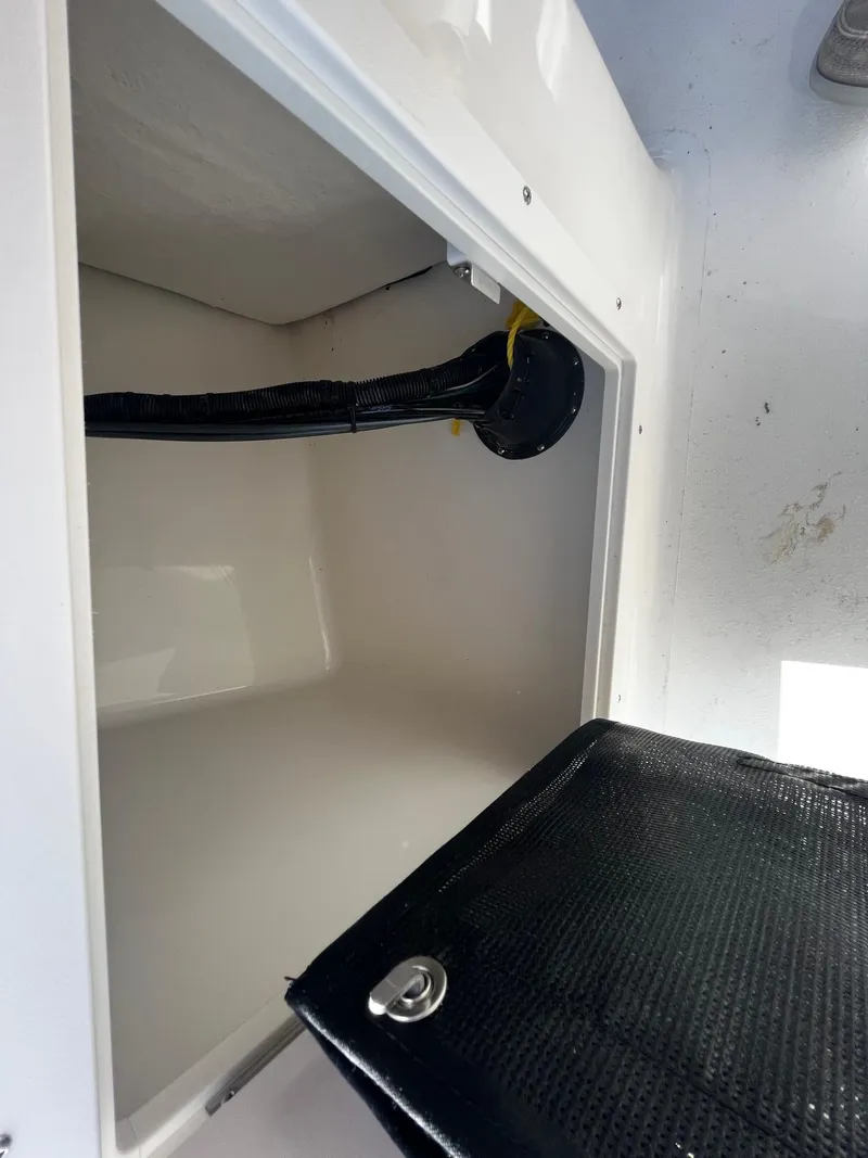 Slide: The Image of Open storage compartment in 2024 Key West 203 DFS boat. - 9