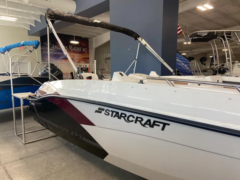 Slide: The Image of 2024 Starcraft SVX 171 boat on display in a showroom. - 1