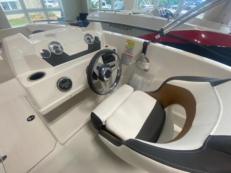 Slide: The Image of 2024 Starcraft SVX 171 boat interior with steering wheel and dashboard. - 10