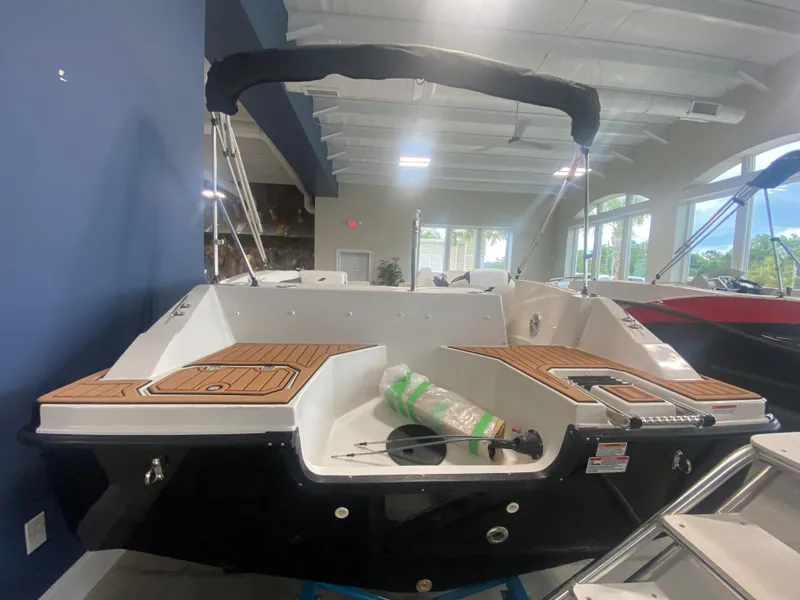 Slide: The Image of 2024 Starcraft SVX 171 boat interior with teak flooring in showroom. - 2