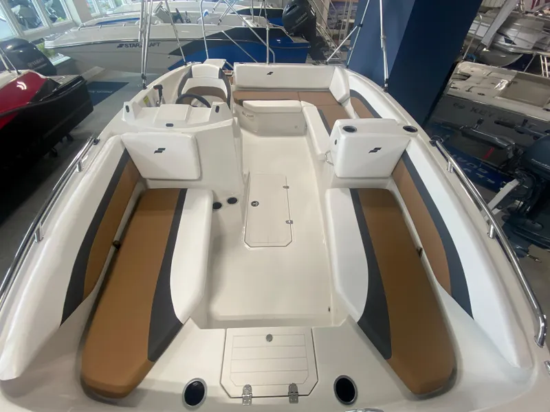 Slide: The Image of 2024 Starcraft SVX 171 boat interior with brown and white seating. - 6