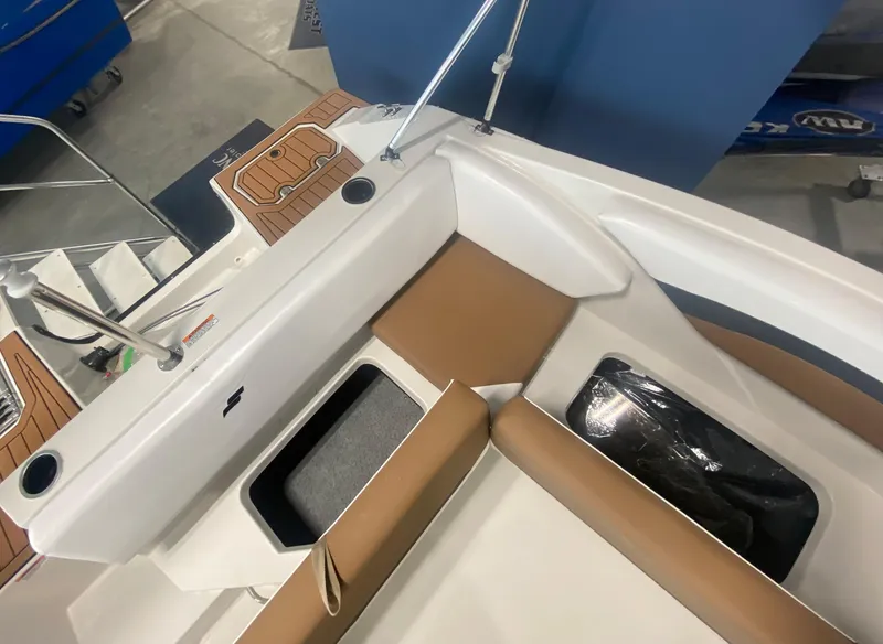 Slide: The Image of 2024 Starcraft SVX 171 boat interior with tan and white seating. - 9