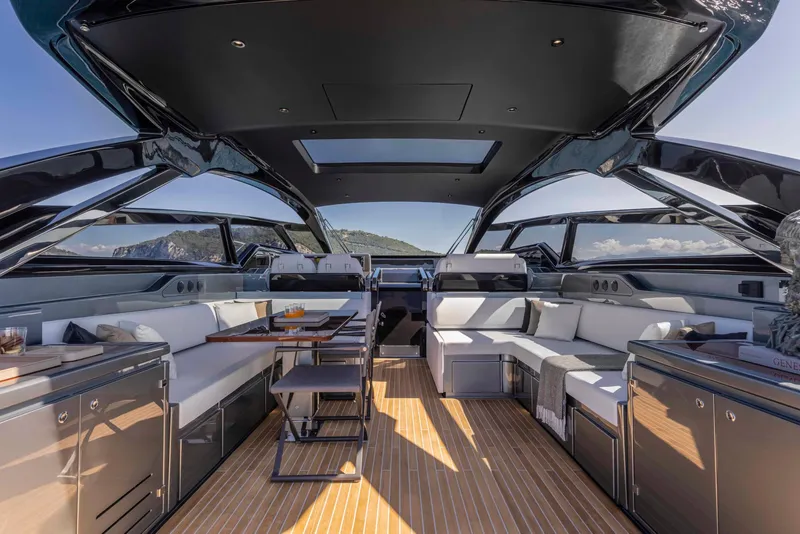 Slide: The Image of Luxurious interior of the 2025 Riva 68' DIABLE yacht with modern seating and panoramic windows. - 10