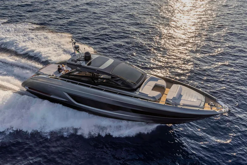 Slide: The Image of 2025 Riva 68' DIABLE luxury yacht cruising on the ocean at sunset. - 2