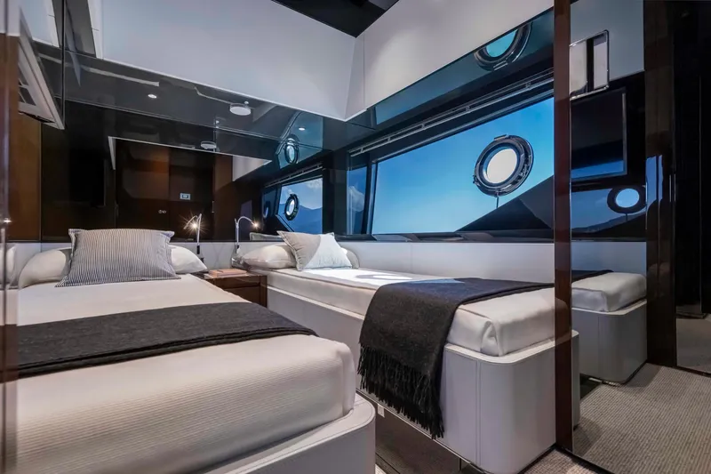 Slide: The Image of Luxurious cabin interior of 2025 Riva 68' DIABLE yacht with twin beds and modern design. - 23