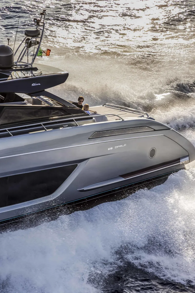Slide: The Image of 2025 Riva 68' DIABLE luxury yacht cruising on water. - 3