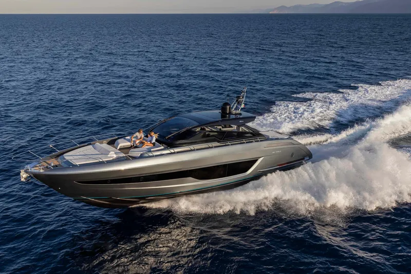 Slide: The Image of 2025 Riva 68' DIABLE luxury yacht cruising on open water. - 4