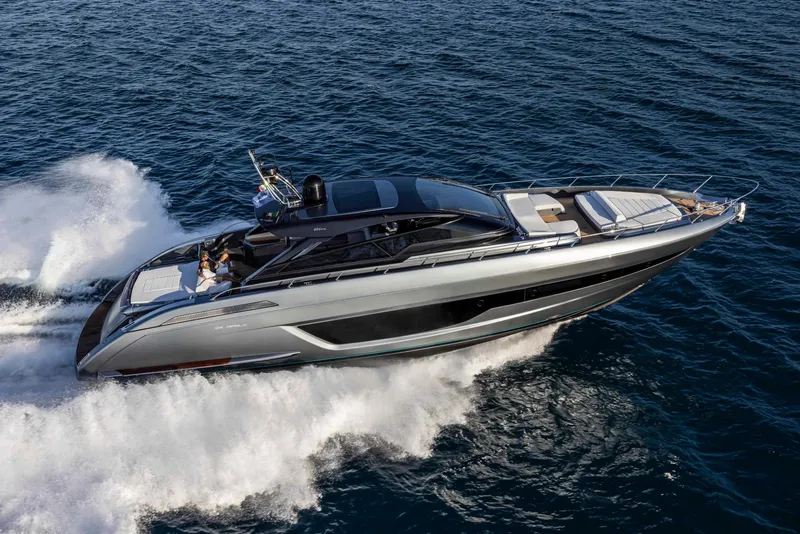 Slide: The Image of 2025 Riva 68' DIABLE luxury yacht cruising on open water. - 6
