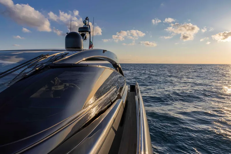 Slide: The Image of Riva 68' DIABLE 2025 yacht cruising on the ocean at sunset. - 8