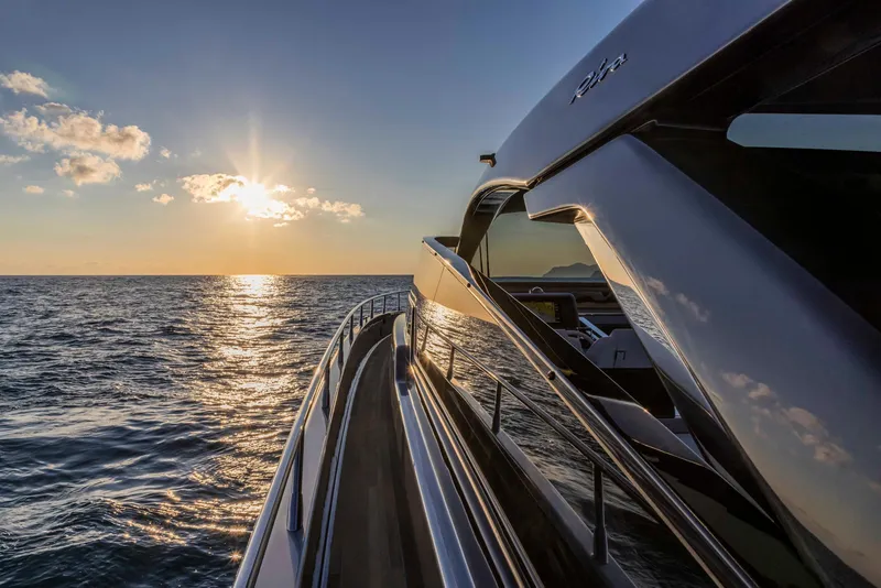Slide: The Image of 2025 Riva 68' DIABLE yacht cruising at sunset on the open sea. - 9