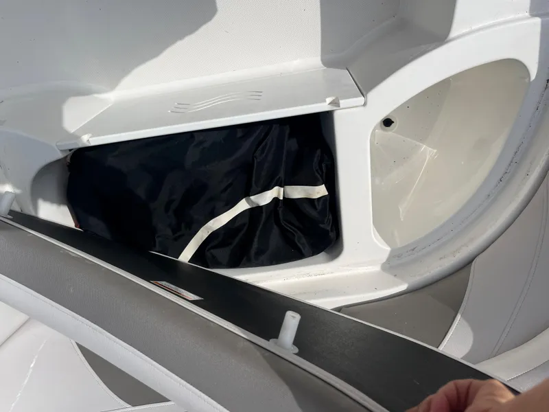 Slide: The Image of 2017 Hurricane SD 2400 I/O boat storage compartment with black bag. - 13