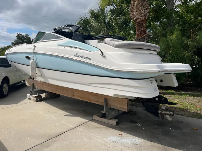 Slide: The Image of 2017 Hurricane SD 2400 I/O boat on a stand, white and light blue exterior. - 16