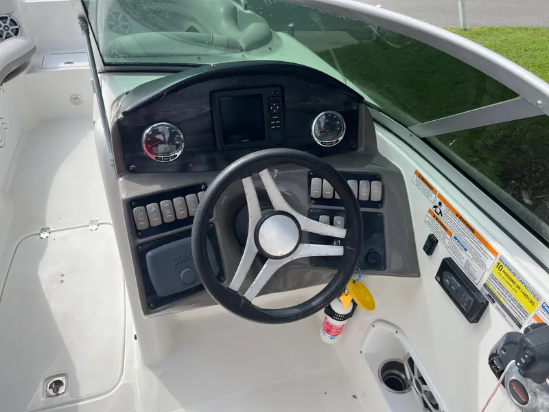 Slide: The Image of 2017 Hurricane SD 2400 I/O boat dashboard with steering wheel and control panel. - 7