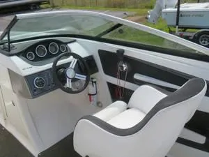 Slide: The Image of 2014 Sea Ray 240SD boat cockpit with steering wheel and dashboard. - 14