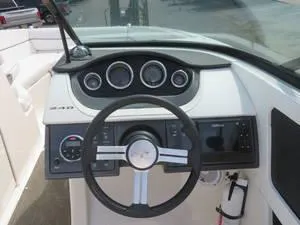Slide: The Image of 2014 Sea Ray 240SD boat dashboard with steering wheel and instrument panel. - 15