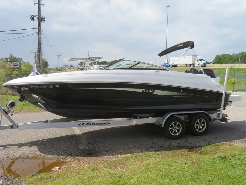 Slide: The Image of 2014 Sea Ray 240SD boat on EZ Loader trailer, black and white exterior. - 2