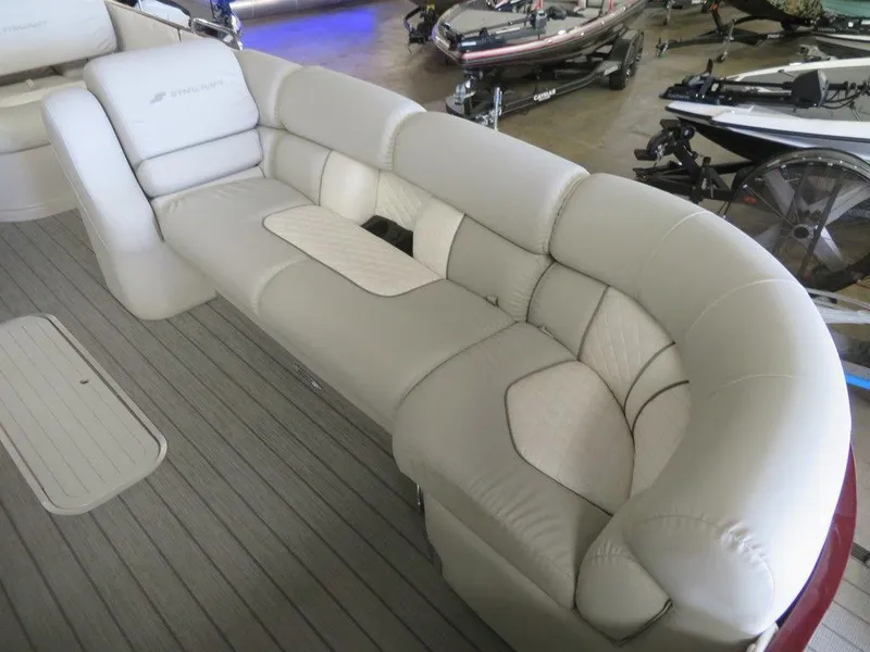 Slide: The Image of 2023 Starcraft SX 25 Q boat with luxurious beige seating. - 10