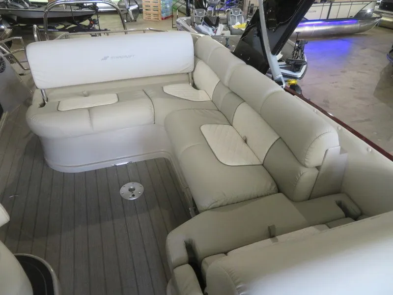 Slide: The Image of 2023 Starcraft SX 25 Q boat interior with luxurious beige seating. - 16