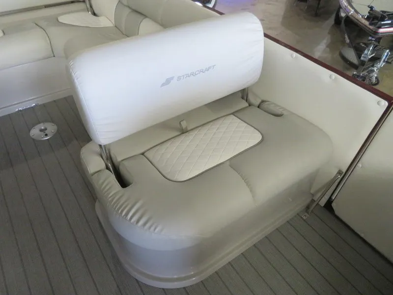 Slide: The Image of 2023 Starcraft SX 25 Q boat interior seating with white upholstery. - 17