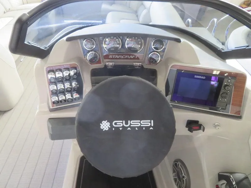 Slide: The Image of 2023 Starcraft SX 25 Q boat dashboard with Gussi Italia steering wheel and Simrad display. - 18