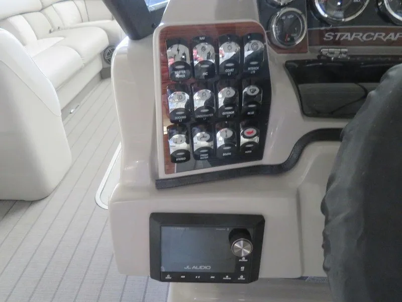 Slide: The Image of Control panel of 2023 Starcraft SX 25 Q boat with JL Audio system. - 21
